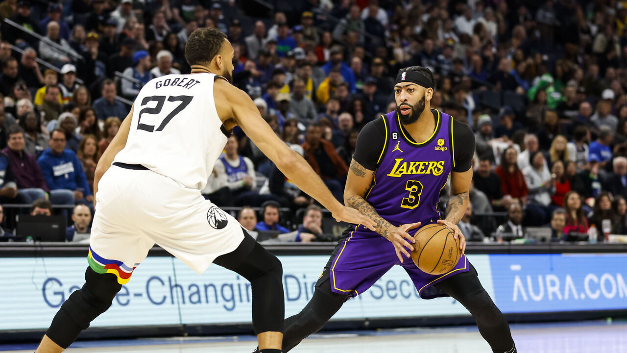 MINNEAPOLIS, MN - MARCH 31: Anthony Davis #3 of the Los Angeles Lakers dribbles the ball while Rudy Gobert #27 of the Minnesota Timberwolves defends in the first quarter of the game at Target Center on March 31, 2023 in Minneapolis, Minnesota.