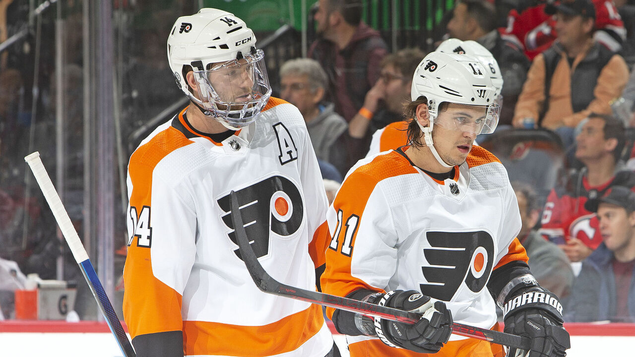 NEWARK, NJ - DECEMBER 08: Sean Couturier #14 of the Philadelphia Flyers talks with Travis Konecny #11 during the first period against the New Jersey Devils at the Prudential Center on December 8, 2021 in Newark, New Jersey.