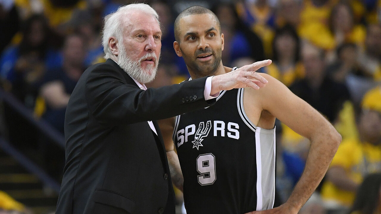 OAKLAND, CA - APRIL 14: Head coach Gregg Popovich of the San Antonio Spurs talks with his player Tony Parker #9 against the Golden State Warriors in the second quarter during Game One of the first round of the 2018 NBA Playoff at ORACLE Arena on April 14, 2018 in Oakland, California.