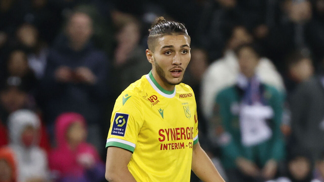PARIS, FRANCE - MARCH 04: Jaouen Hadjam #26 of FC Nantes gets a yellow card from the referee Jeremy Stinat during the Ligue 1 match between Paris Saint-Germain and FC Nantes at Parc des Princes on March 4, 2023 in Paris, France.
