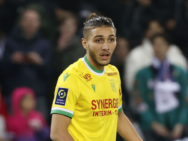 PARIS, FRANCE - MARCH 04: Jaouen Hadjam #26 of FC Nantes gets a yellow card from the referee Jeremy Stinat during the Ligue 1 match between Paris Saint-Germain and FC Nantes at Parc des Princes on March 4, 2023 in Paris, France.