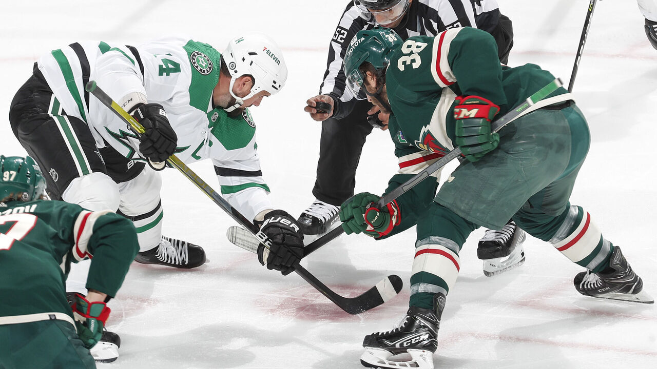 SAINT PAUL, MN - FEBRUARY 17: Ryan Hartman #38 of the Minnesota Wild takes a faceoff against Jamie Benn #14 of the Dallas Stars during the game at the Xcel Energy Center on February 17, 2023 in Saint Paul, Minnesota.