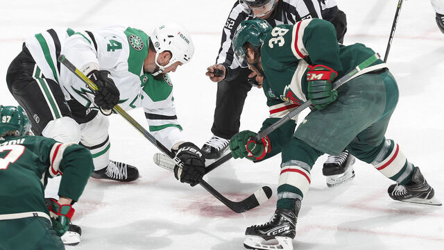 SAINT PAUL, MN - FEBRUARY 17: Ryan Hartman #38 of the Minnesota Wild takes a faceoff against Jamie Benn #14 of the Dallas Stars during the game at the Xcel Energy Center on February 17, 2023 in Saint Paul, Minnesota.