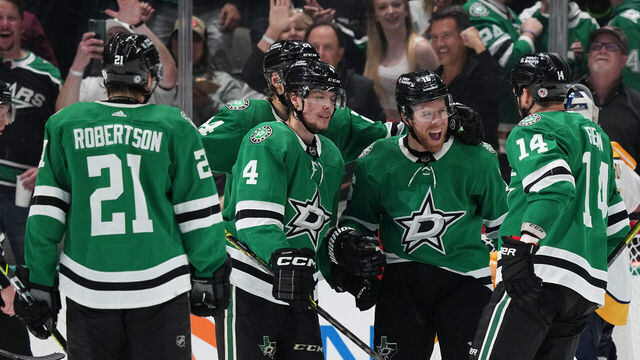 DALLAS, TX - APRIL 3: Jason Robertson #21, Miro Heiskanen #4, Jamie Benn #14 and Joe Pavelski #16 of the Dallas Stars celebrate a goal against the Nashville Predators at the American Airlines Center on April 3, 2023 in Dallas, Texas.