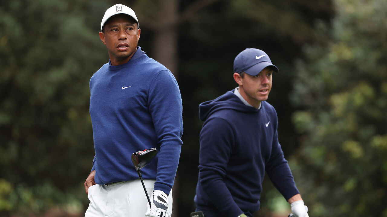 AUGUSTA, GEORGIA - APRIL 03: Tiger Woods of the United States and Rory McIlroy of Northern Ireland look on from the 11th tee during a practice round prior to the 2023 Masters Tournament at Augusta National Golf Club on April 03, 2023 in Augusta, Georgia.