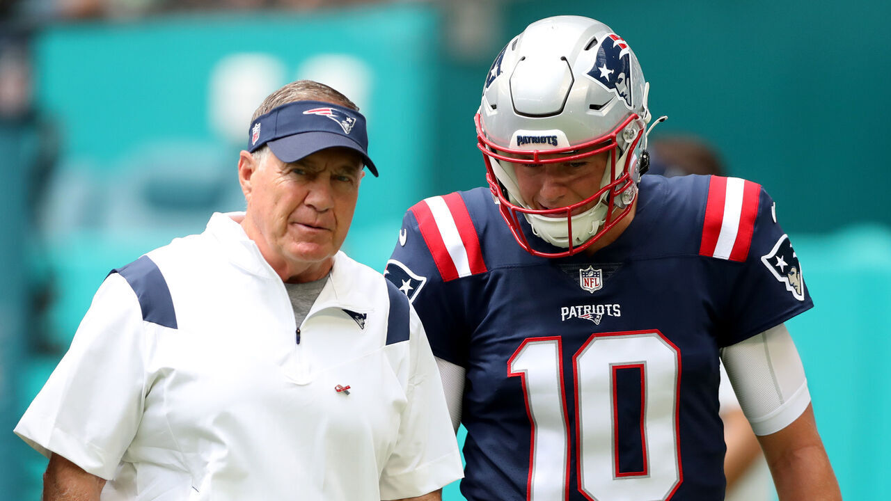MIAMI GARDENS, FLORIDA - SEPTEMBER 11: Head coach Bill Belichick and Mac Jones #10 look on during pregame at Hard Rock Stadium on September 11, 2022 in Miami Gardens, Florida.