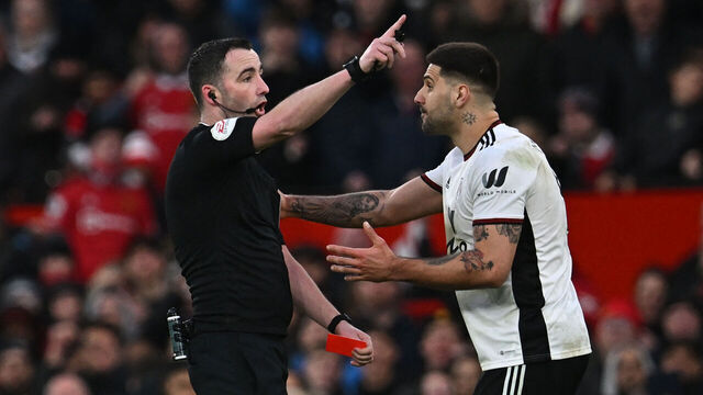 Fulham's Serbian striker Aleksandar Mitrovic (R) is shown a red card by English referee Chris Kavanagh (L) during the English FA Cup quarter-final football match between Manchester United and Fulham at Old Trafford in Manchester, north-west England, on March 19, 2023.