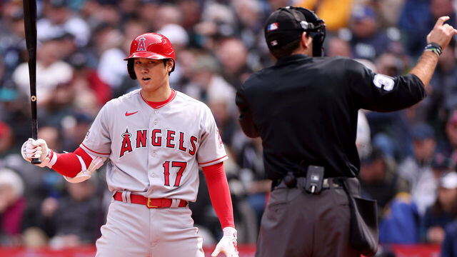 SEATTLE, WASHINGTON - APRIL 05: Umpire Pat Hoberg #31 calls Shohei Ohtani #17 of the Los Angeles Angels for a pitch clock violation during the sixth inning against the Seattle Mariners at T-Mobile Park on April 05, 2023 in Seattle, Washington.