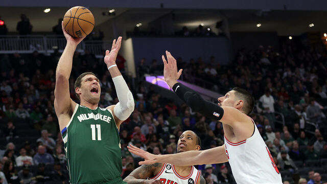 MILWAUKEE, WISCONSIN - APRIL 05: Brook Lopez #11 of the Milwaukee Bucks shoots over Nikola Vucevic #9 of the Chicago Bulls during the second half of a game at Fiserv Forum on April 05, 2023 in Milwaukee, Wisconsin.