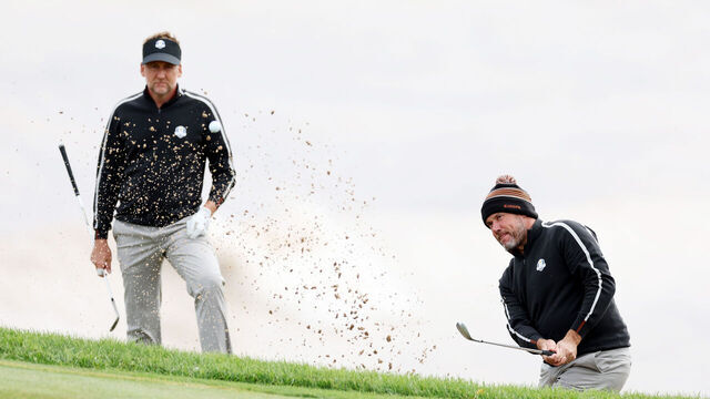 KOHLER, WISCONSIN - SEPTEMBER 23: Lee Westwood of England and team Europe plays his shot from the bunker as Ian Poulter of England and team Europe looks on during practice rounds prior to the 43rd Ryder Cup at Whistling Straits on September 23, 2021 in Kohler, Wisconsin.