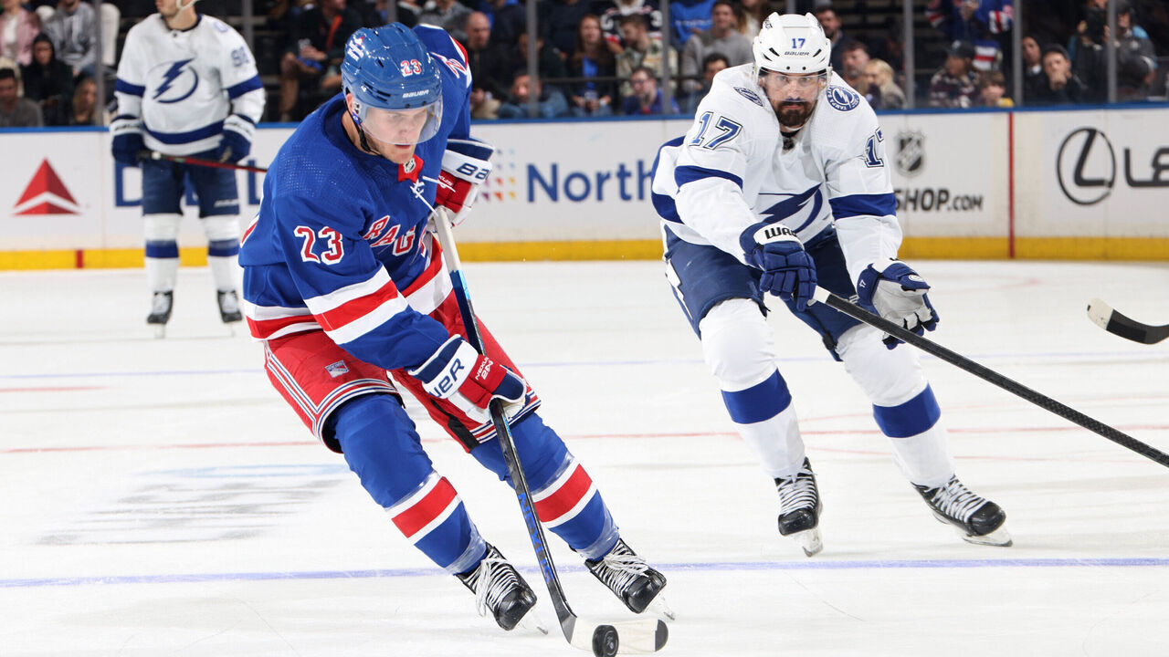 NEW YORK, NEW YORK - OCTOBER 11: Adam Fox #23 of the New York Rangers skates with the puck against Alex Killorn #17 of the Tampa Bay Lightning at Madison Square Garden on October 11, 2022 in New York City.