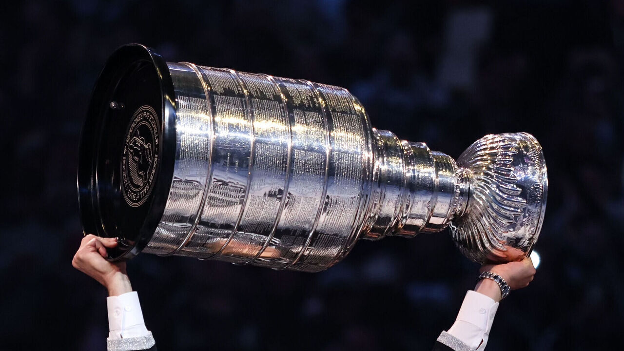 LOS ANGELES, CALIFORNIA - FEBRUARY 11: Former Los Angeles Kings player Dustin Brown lifts the Stanley Cup during a ceremony as his jersey number is retired before the game against the Pittsburgh Penguins at Crypto.com Arena on February 11, 2023 in Los Angeles, California.