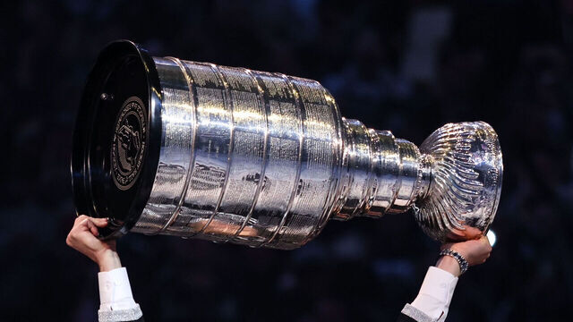 LOS ANGELES, CALIFORNIA - FEBRUARY 11: Former Los Angeles Kings player Dustin Brown lifts the Stanley Cup during a ceremony as his jersey number is retired before the game against the Pittsburgh Penguins at Crypto.com Arena on February 11, 2023 in Los Angeles, California.