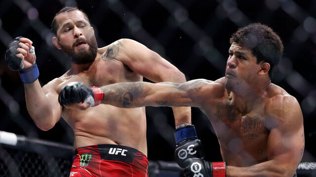 MIAMI, FLORIDA - APRIL 08: Gilbert Burns (R) of Brazil punches Jorge Masvidal in their welterweight bout during UFC 287 at Kaseya Center on April 08, 2023 in Miami, Florida.