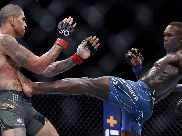 MIAMI, FLORIDA - APRIL 08: Israel Adesanya (R) of Nigeria kicks Alex Pereira of Brazil in their middleweight title bout during UFC 287 at Kaseya Center on April 08, 2023 in Miami, Florida.