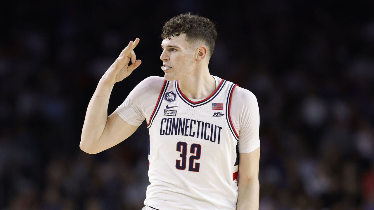 HOUSTON, TEXAS - APRIL 03: Donovan Clingan #32 of the Connecticut Huskies reacts after teammate Joey Calcaterra #3 (not pictured) makes a three-point basket during the second half against the San Diego State Aztecs during the NCAA Men's Basketball Tournament National Championship game at NRG Stadium on April 03, 2023 in Houston, Texas.