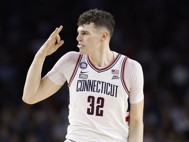 HOUSTON, TEXAS - APRIL 03: Donovan Clingan #32 of the Connecticut Huskies reacts after teammate Joey Calcaterra #3 (not pictured) makes a three-point basket during the second half against the San Diego State Aztecs during the NCAA Men's Basketball Tournament National Championship game at NRG Stadium on April 03, 2023 in Houston, Texas.
