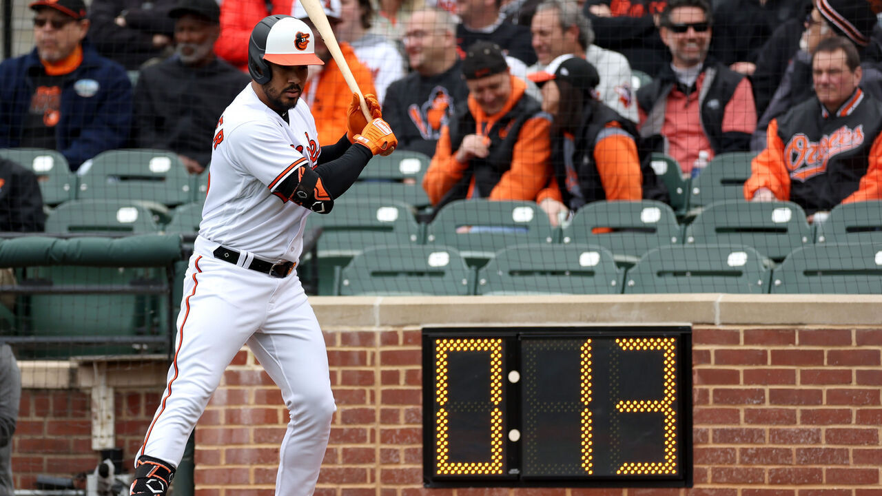 BALTIMORE, MARYLAND - APRIL 07: Anthony Santander #25 of the Baltimore Orioles waits to bat next to the pitch clock during the Orioles home opener against the New York Yankees at Oriole Park at Camden Yards on April 07, 2023 in Baltimore, Maryland.