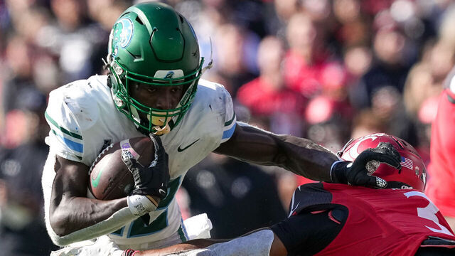 CINCINNATI, OHIO - NOVEMBER 25: Tyjae Spears #22 of the Tulane Green Wave runs with the ball while being chased by Ja'Von Hicks #3 of the Cincinnati Bearcats in the second quarter at Nippert Stadium on November 25, 2022 in Cincinnati, Ohio.