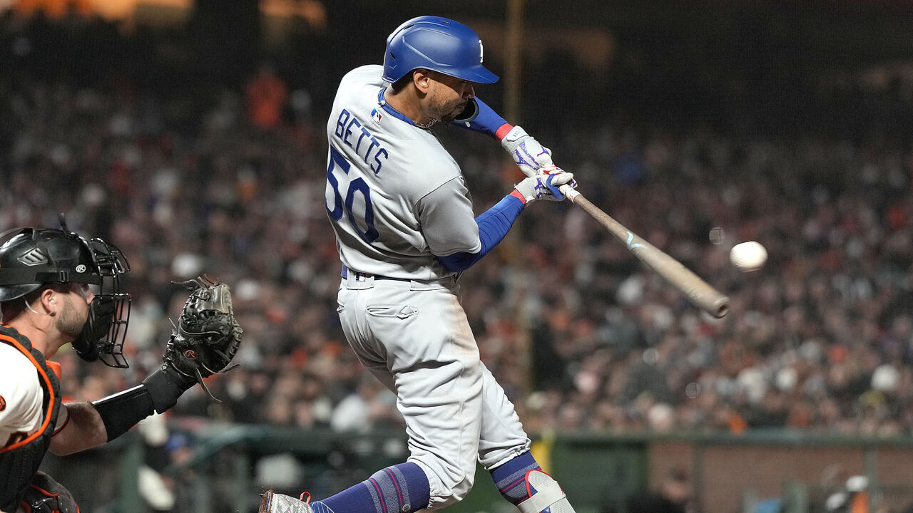 SAN FRANCISCO, CALIFORNIA - APRIL 10: Mookie Betts #50 of the Los Angeles Dodgers hits an RBI single scoring James Outman #33 against the San Francisco Giants in the top of the seventh inning at Oracle Park on April 10, 2023 in San Francisco, California.