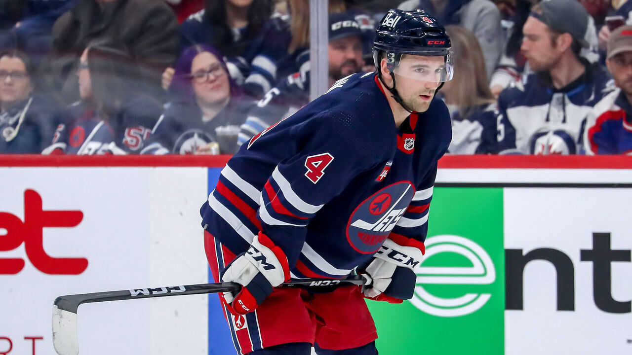 WINNIPEG, CANADA - MARCH 31: Neal Pionk #4 of the Winnipeg Jets looks on during a first period stoppage in play against the Detroit Red Wings at the Canada Life Centre on March 31, 2023 in Winnipeg, Manitoba, Canada. The Jets defeated the Wings 6-2.