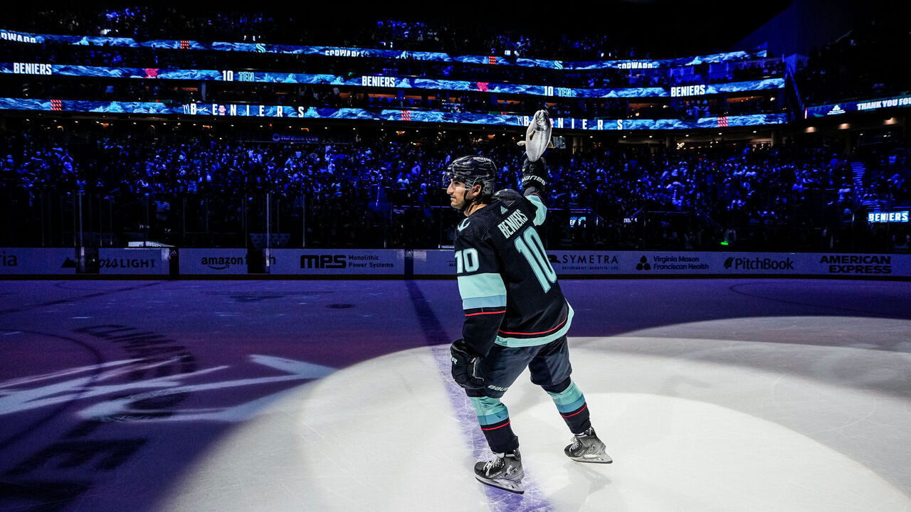 SEATTLE, WASHINGTON - APRIL 6:Matty Beniers #10 of the Seattle Kraken waves a plush toy salmon to the home crowd after a victory against the Arizona Coyotes, which sends them to the Stanley Cup Playoffs for the first time in franchise history, at Climate Pledge Arena on April 6 2023 in Seattle, Washington.