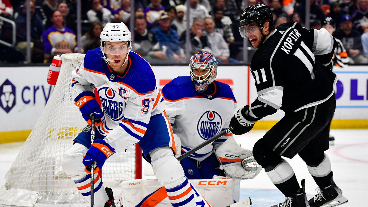 LOS ANGELES, CA - APRIL 4: Connor McDavid #97 of the Edmonton Oilers skates with the puck with pressure from Anze Kopitar #11 of the Los Angeles Kings during the third period at Crypto.com Arena on April 4, 2023 in Los Angeles, California.