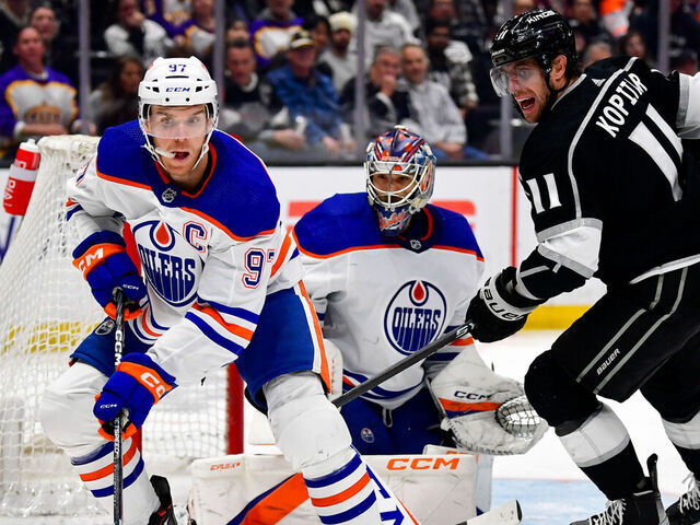 LOS ANGELES, CA - APRIL 4: Connor McDavid #97 of the Edmonton Oilers skates with the puck with pressure from Anze Kopitar #11 of the Los Angeles Kings during the third period at Crypto.com Arena on April 4, 2023 in Los Angeles, California.