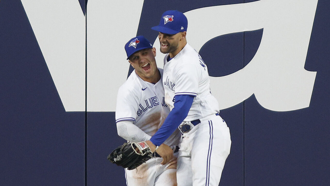 TORONTO, ON - APRIL 14: Daulton Varsho #25 of the Toronto Blue Jays and Kevin Kiermaier #39 celebrate Versho's catch at the wall from the bat of Yandy Diaz #2 of the Tampa Bay Rays in the fourth inning of their MLB game at Rogers Centre on April 14, 2023 in Toronto, Canada.