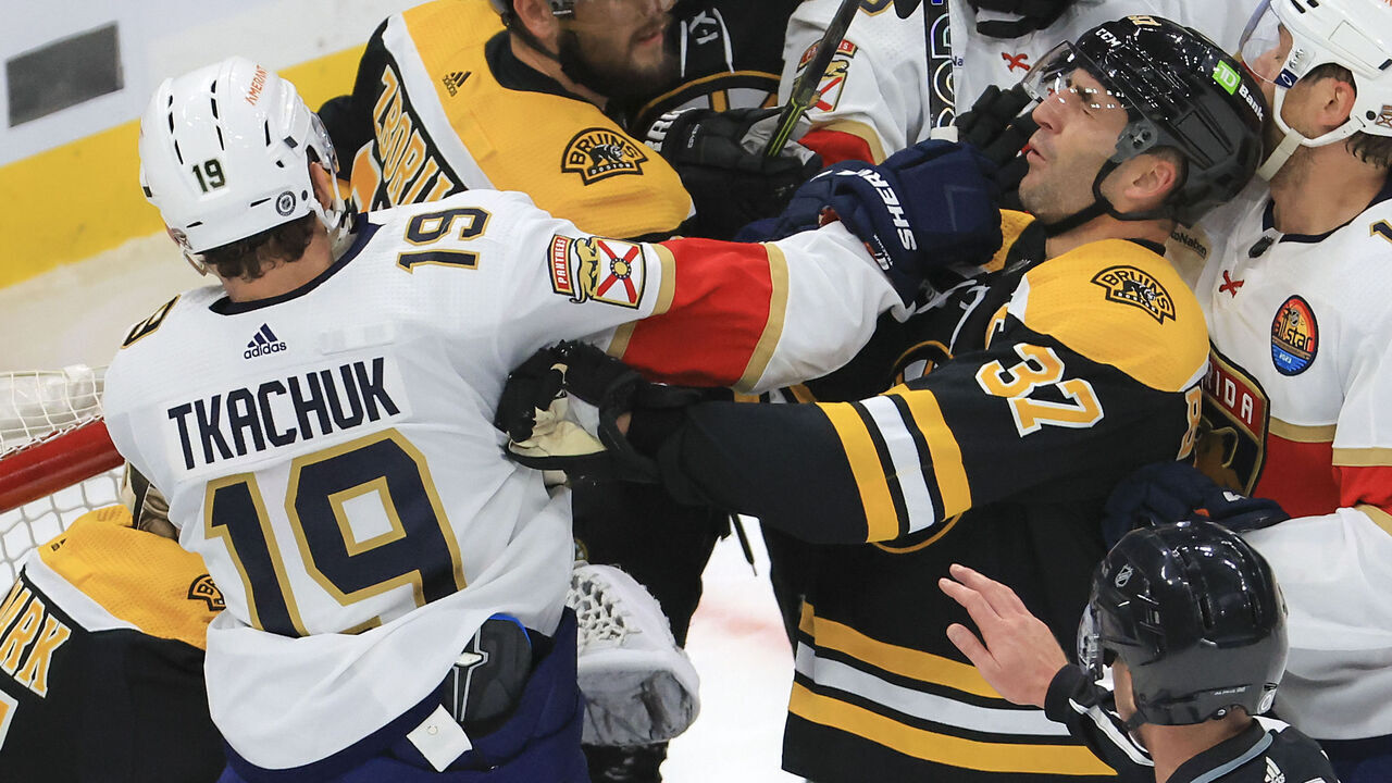 Boston, MA - October 17: Boston Bruins center Patrice Bergeron and Florida Panthers left wing Matthew Tkachuk get physical in front of the Bruins net during first period action. The Bruins beat the Panthers 5-3.
