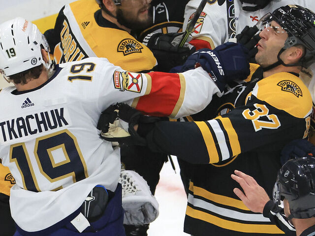 Boston, MA - October 17: Boston Bruins center Patrice Bergeron and Florida Panthers left wing Matthew Tkachuk get physical in front of the Bruins net during first period action. The Bruins beat the Panthers 5-3.