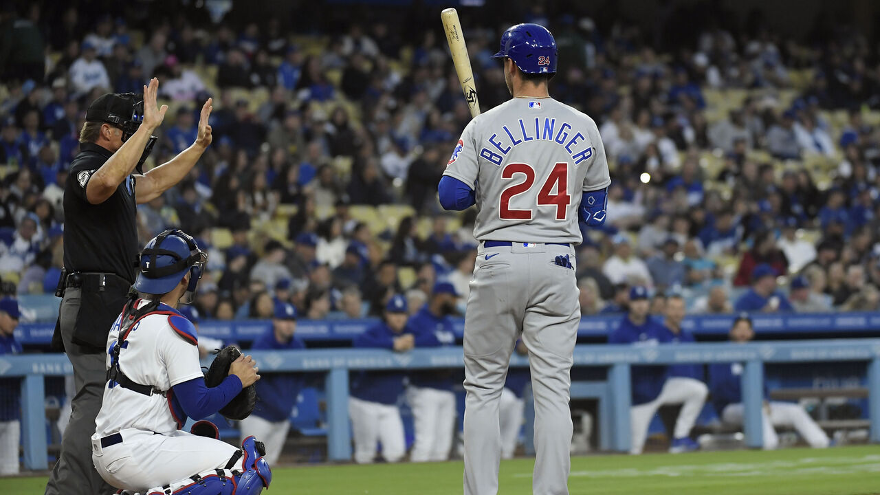 LOS ANGELES, CA - APRIL 14: Cody Bellinger #24 of the Chicago Cubs is charged with pitch-clock violation by home plate umpire Jim Wolf #28 with catcher Austin Barnes #15 of the Los Angeles Dodgers looking on during the second inning at Dodger Stadium on April 14, 2023 in Los Angeles, California.