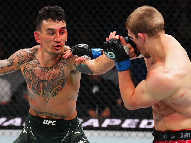 KANSAS CITY, MISSOURI - APRIL 15: (L-R) Max Holloway punches Arnold Allen of England in a featherweight fight during the UFC Fight Night event at T-Mobile Center on April 15, 2023 in Kansas City, Missouri.