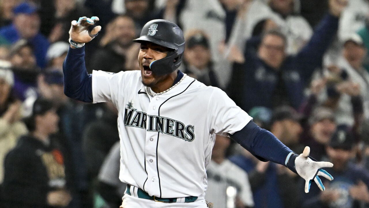 SEATTLE, WASHINGTON - APRIL 15: Julio Rodriguez #42 of the Seattle Mariners celebrates after hitting a triple during the fourth inning of the game against the Colorado Rockies at T-Mobile Park on April 15, 2023 in Seattle, Washington. All players are wearing the number 42 in honor of Jackie Robinson Day.