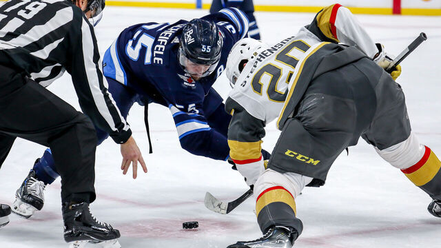 WINNIPEG, CANADA - DECEMBER 13: Mark Scheifele #55 of the Winnipeg Jets takes a second period face-off against Chandler Stephenson #20 of the Vegas Golden Knights at the Canada Life Centre on December 13, 2022 in Winnipeg, Manitoba, Canada.
