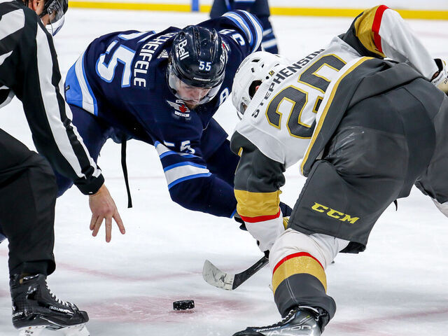 WINNIPEG, CANADA - DECEMBER 13: Mark Scheifele #55 of the Winnipeg Jets takes a second period face-off against Chandler Stephenson #20 of the Vegas Golden Knights at the Canada Life Centre on December 13, 2022 in Winnipeg, Manitoba, Canada.
