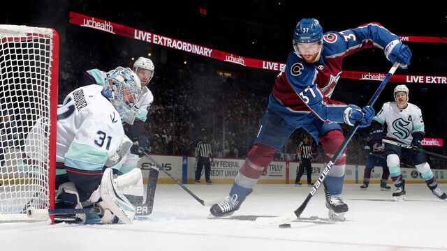 DENVER, COLORADO - OCTOBER 21: J.T. Compher #37 of the Colorado Avalanche skates against goaltender Philipp Grubauer #31 of the Seattle Kraken at Ball Arena on October 21, 2022 in Denver, Colorado. The Kraken defeated the Avalanche 3-2.