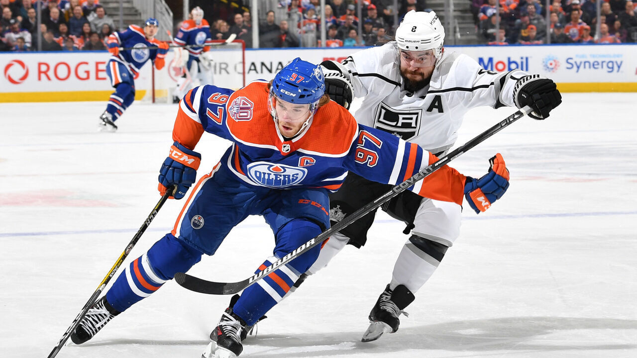 EDMONTON, AB - NOVEMBER 29: Connor McDavid #97 of the Edmonton Oilers skates with the puck while being pursued by Drew Doughty #8 of the Los Angeles Kings on November 29, 2018 at Rogers Place in Edmonton, Alberta, Canada.