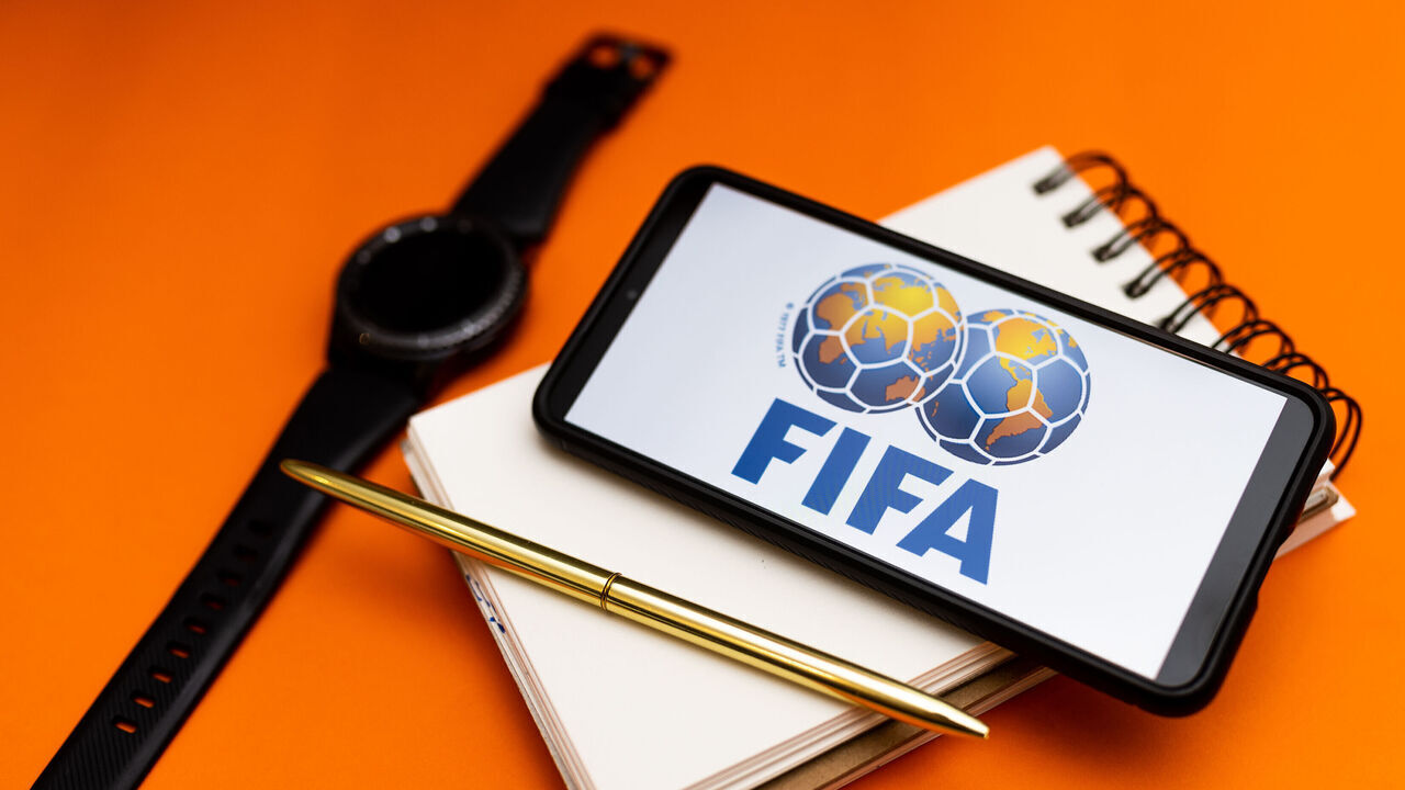 POLAND - 2022/12/07: In this photo illustration a FIFA logo seen displayed on a smartphone. (Photo Illustration by Mateusz Slodkowski/SOPA Images/LightRocket via Getty Images)