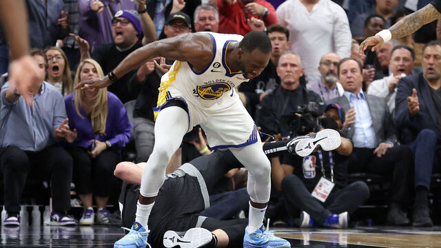 SACRAMENTO, CALIFORNIA - APRIL 17: Draymond Green #23 of the Golden State Warriors steps over Domantas Sabonis #10 of the Sacramento Kings in the second half during Game Two of the Western Conference First Round Playoffs at Golden 1 Center on April 17, 2023 in Sacramento, California. Green was issued a flagrant foul 2 on the play, and ejected from the game.