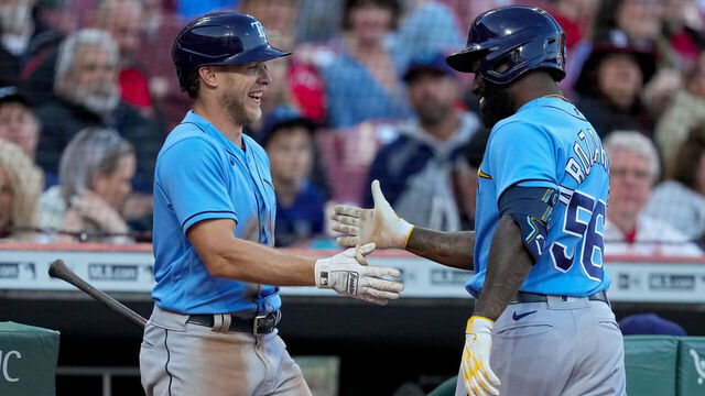 CINCINNATI, OHIO - APRIL 18: Taylor Walls #6 and Randy Arozarena #56 of the Tampa Bay Rays celebrate after Arozarena hit a home run in the fourth inning against the Cincinnati Reds at Great American Ball Park on April 18, 2023 in Cincinnati, Ohio.