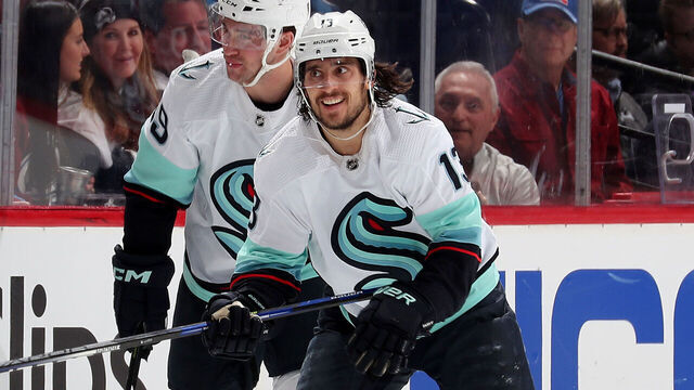 DENVER, COLORADO - APRIL 20: Vince Dunn #29, Brandon Tanev #13 and Will Borgen #3 of the Seattle Kraken celebrate a goal against the Colorado Avalanche in Game Two of the First Round of the Stanley Cup Playoffs at Ball Arena on April 20, 2023 in Denver, Colorado.
