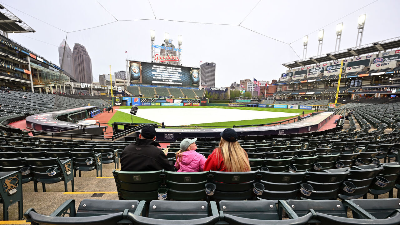CLEVELAND, OHIO - APRIL 21: Fans linger in the stands after the game between the Cleveland Guardians and the Miami Marlins was postponed due to inclement weather at Progressive Field on April 21, 2023 in Cleveland, Ohio. A double header will be played tomorrow.