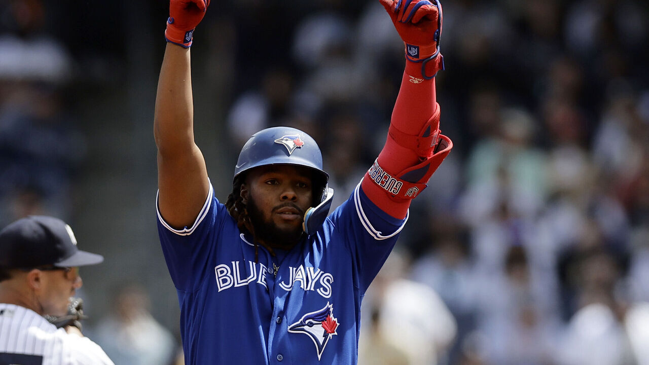 BRONX, NEW YORK - APRIL 22: Vladimir Guerrero Jr. #27 of the Toronto Blue Jays reacts at second base after hitting a double as Gleyber Torres #25 of the New York Yankees looks on during the first inning of the game at Yankee Stadium on April 22, 2023 in Bronx, New York.