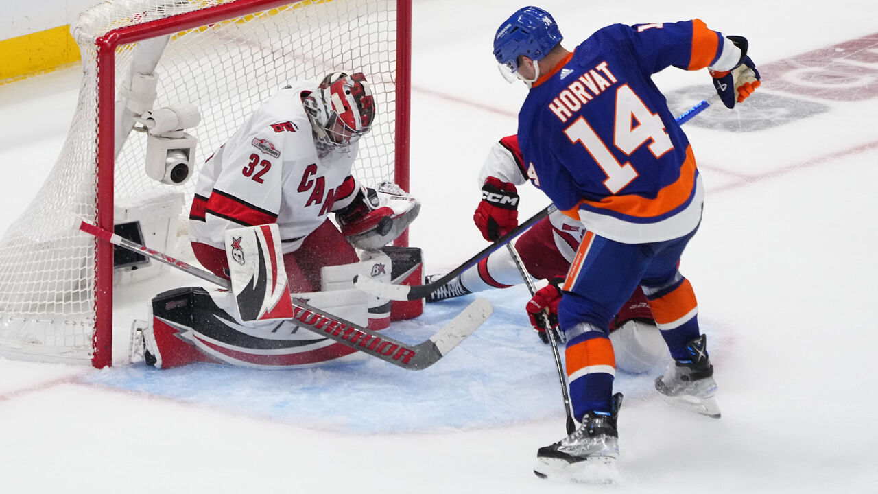 ELMONT, NY - APRIL 21: New York Islanders Center Bo Horvat (14) takes a shot on Carolina Hurricanes Goalie Antti Raanta (32) during the third period of Game 3 of the National Hockey League Eastern Conference First Round Playoff game between the Carolina Hurricanes and New York Islanders on April 21, 2023, at UBS Arena in Elmont, NY.