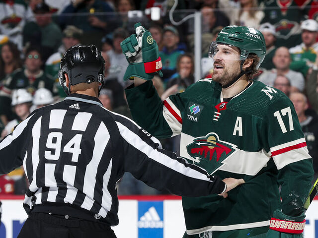 ST PAUL, MN - APRIL 21: Marcus Foligno #17 of the Minnesota Wild is separated by linesman Bryan Pancich #94 after a play in the third period of Game Three of the First Round of the 2023 Stanley Cup Playoffs against the Dallas Stars at Xcel Energy Center on April 21, 2023 in St Paul, Minnesota.