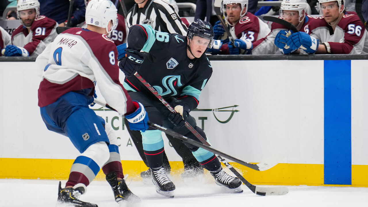 SEATTLE, WASHINGTON - APRIL 20: Jared McCann #16 of the Seattle Kraken looks to make a pass through Cale Makar #8 of the Colorado Avalanche during the third period at Climate Pledge Arena on April 20, 2022 in Seattle, Washington.
