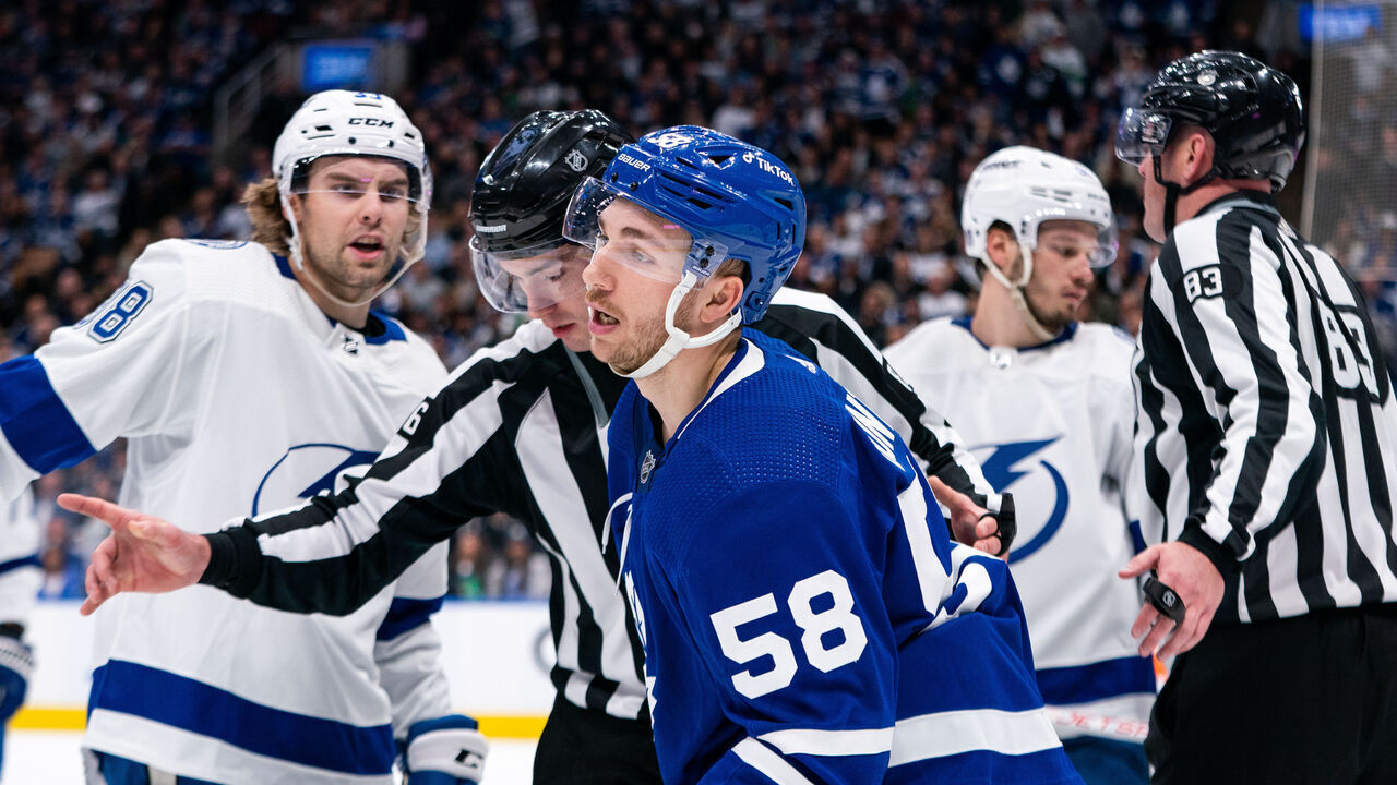 TORONTO, CANADA - APRIL 18: Linesman Jesse Marquis #86 sends Michael Bunting #58 of the Toronto Maple Leafs to the box after hitting Erik Cernak #81 of the Tampa Bay Lightning in Game One of the First Round of the 2023 Stanley Cup Playoffs at the Scotiabank Arena on April 18, 2023 in Toronto, Ontario, Canada.
