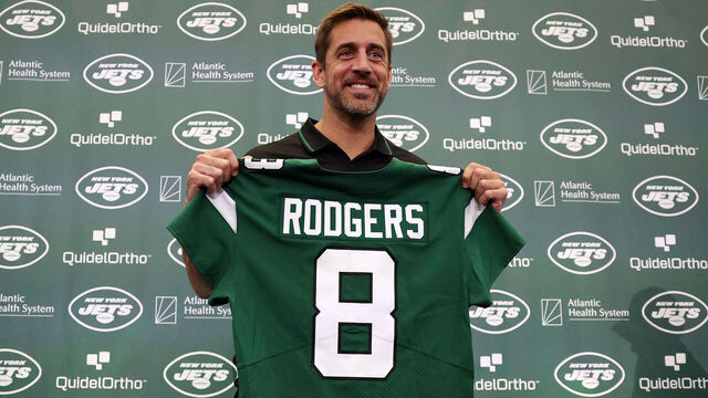 FLORHAM PARK, NEW JERSEY - APRIL 26: New York Jets quarterback Aaron Rodgers poses with a jersey during an introductory press conference at Atlantic Health Jets Training Center on April 26, 2023 in Florham Park, New Jersey.