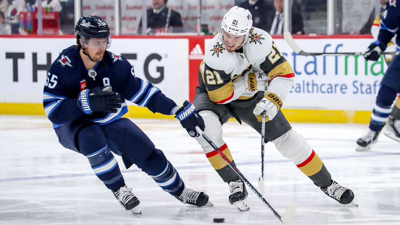 WINNIPEG, CANADA - APRIL 24: Mark Scheifele #55 of the Winnipeg Jets and Brett Howden #21 of the Vegas Golden Knights battle for the loose puck during first period action in Game Four of the First Round of the 2023 Stanley Cup Playoffs at the Canada Life Centre on April 24, 2023 in Winnipeg, Manitoba, Canada.